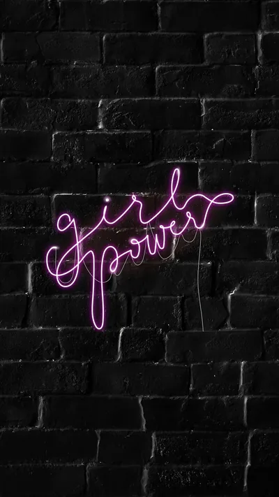 A pink cursive neon sign glows against a black brick wall just above centre, leaving the whole lower half in darkness for icons and the dock.