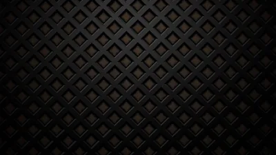 Rows of stitched diamonds run across dark padded material, faint amber light picking out the seams at the centre.