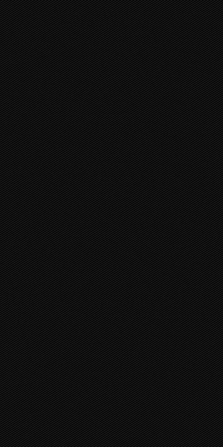 Near-uniform black across the whole frame with a faint fabric-like weave visible only in the lightest patches.