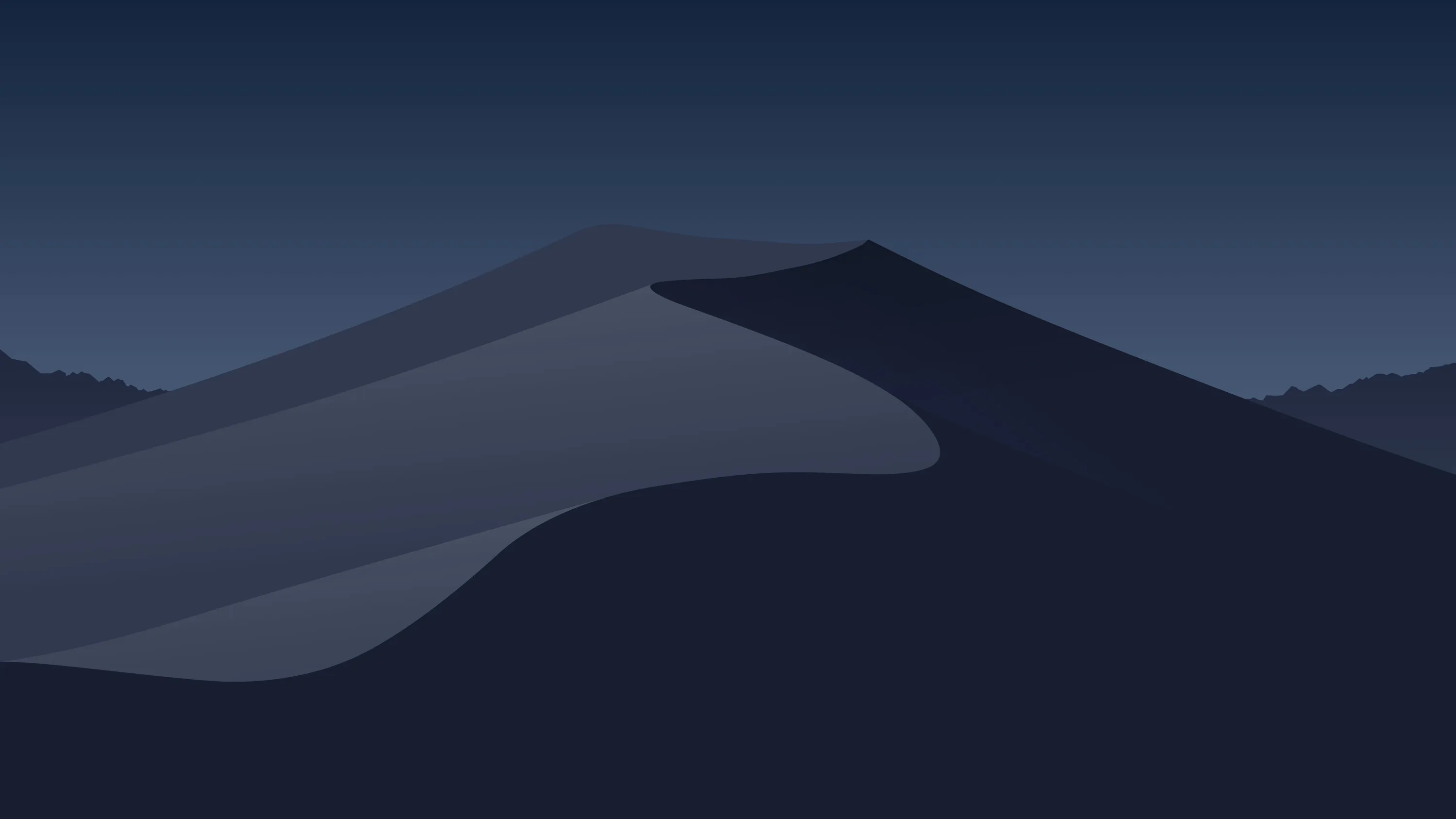 A broad dune curves through deep blue darkness with a second ridge behind it, the sky above graded and completely empty.