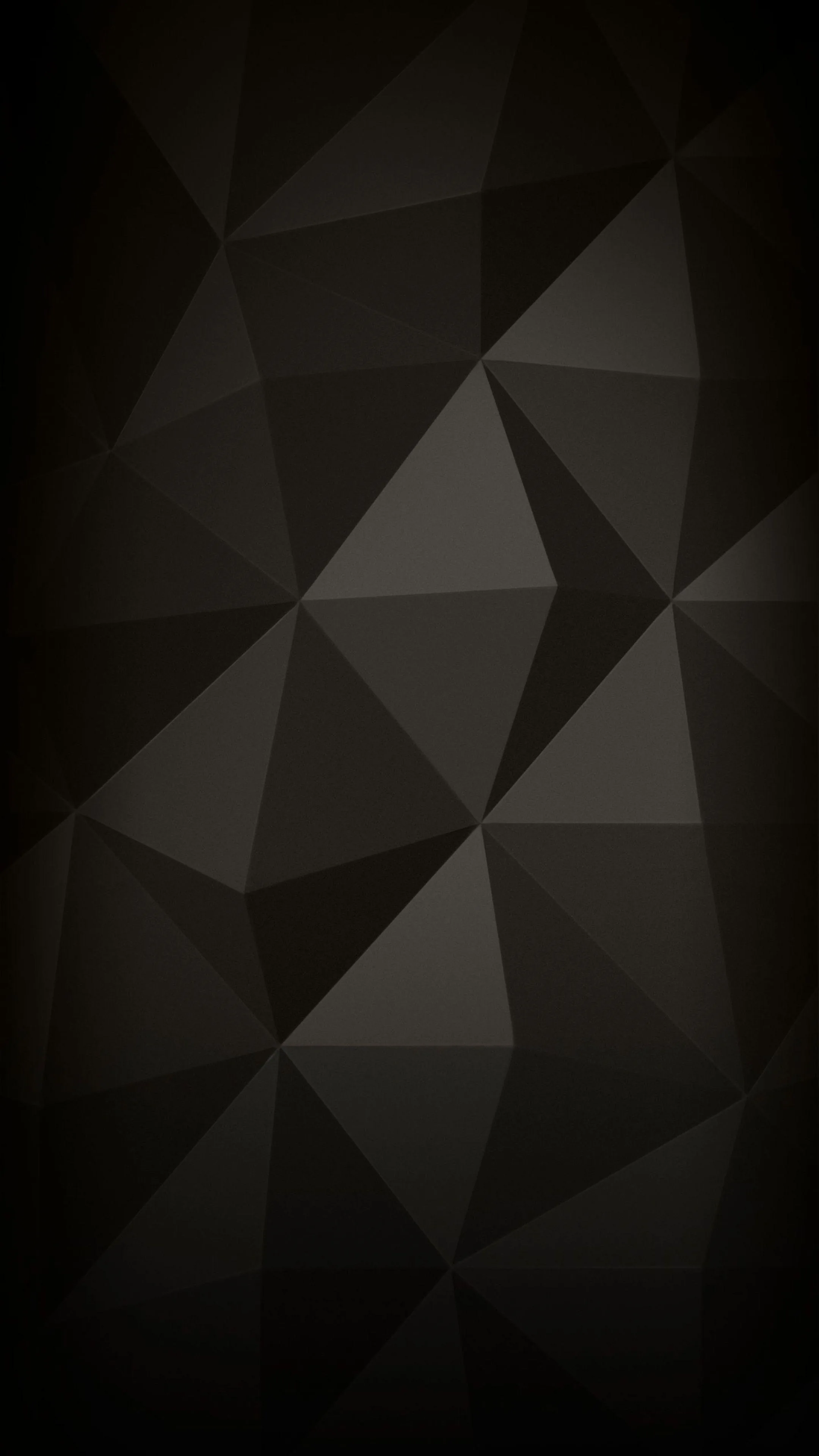 Flat triangular facets tile the whole frame in shades of charcoal, a few lighter panels breaking up the middle.