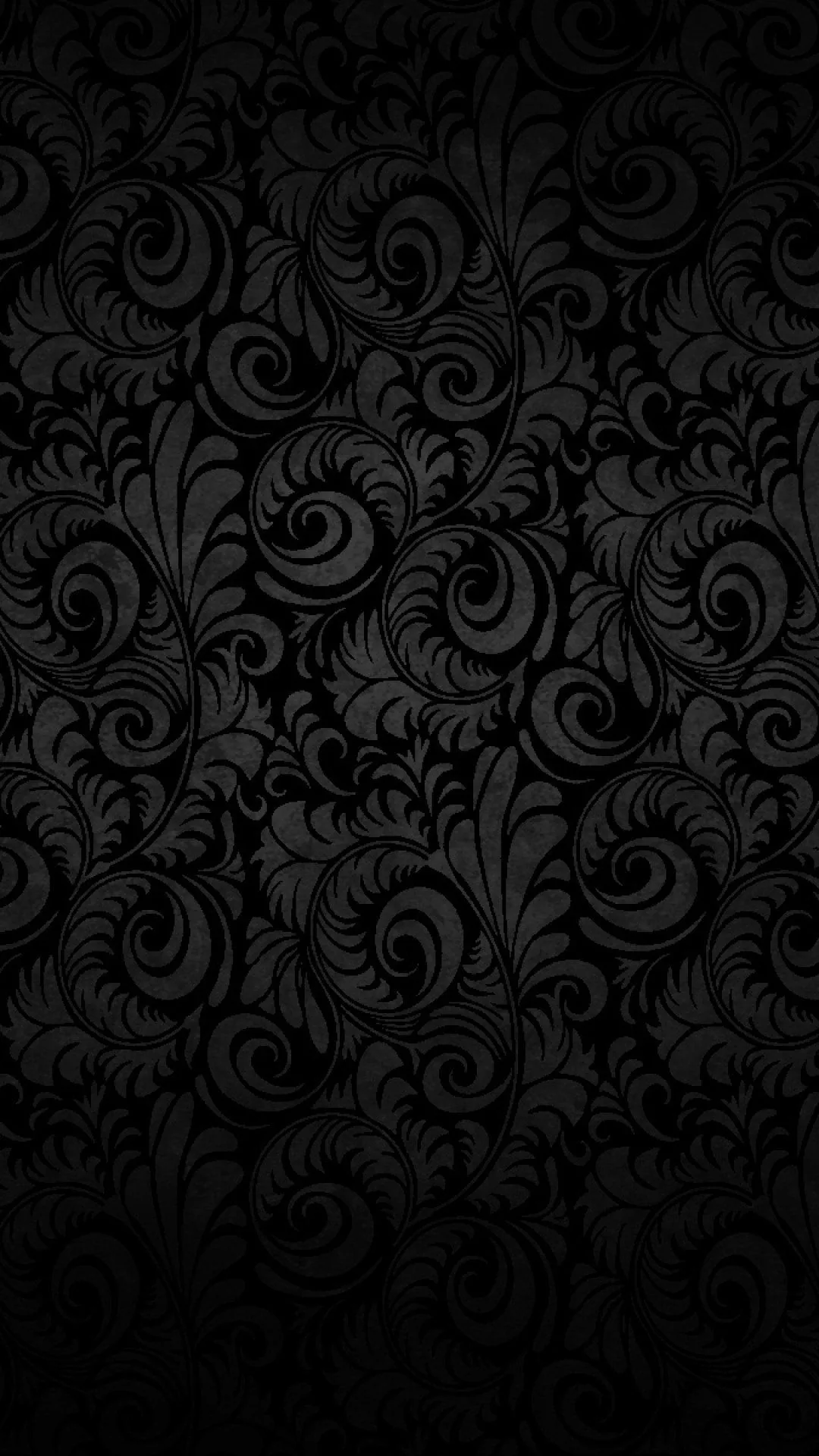 Curling scrollwork repeats over a black ground down a tall frame, the relief only catching light at the top.