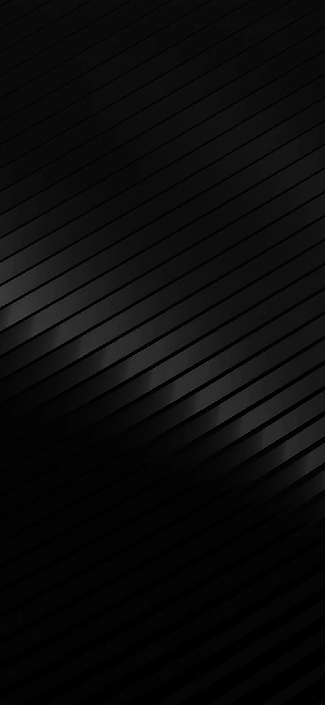 Broad diagonal bands cross the frame in brushed charcoal, a soft sheen crossing from the lower left toward the top.