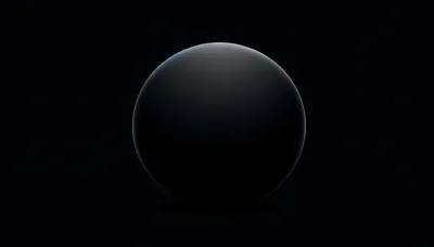 A matte black sphere sits centred in the frame, lit from above so only the top of its curve separates from the background.