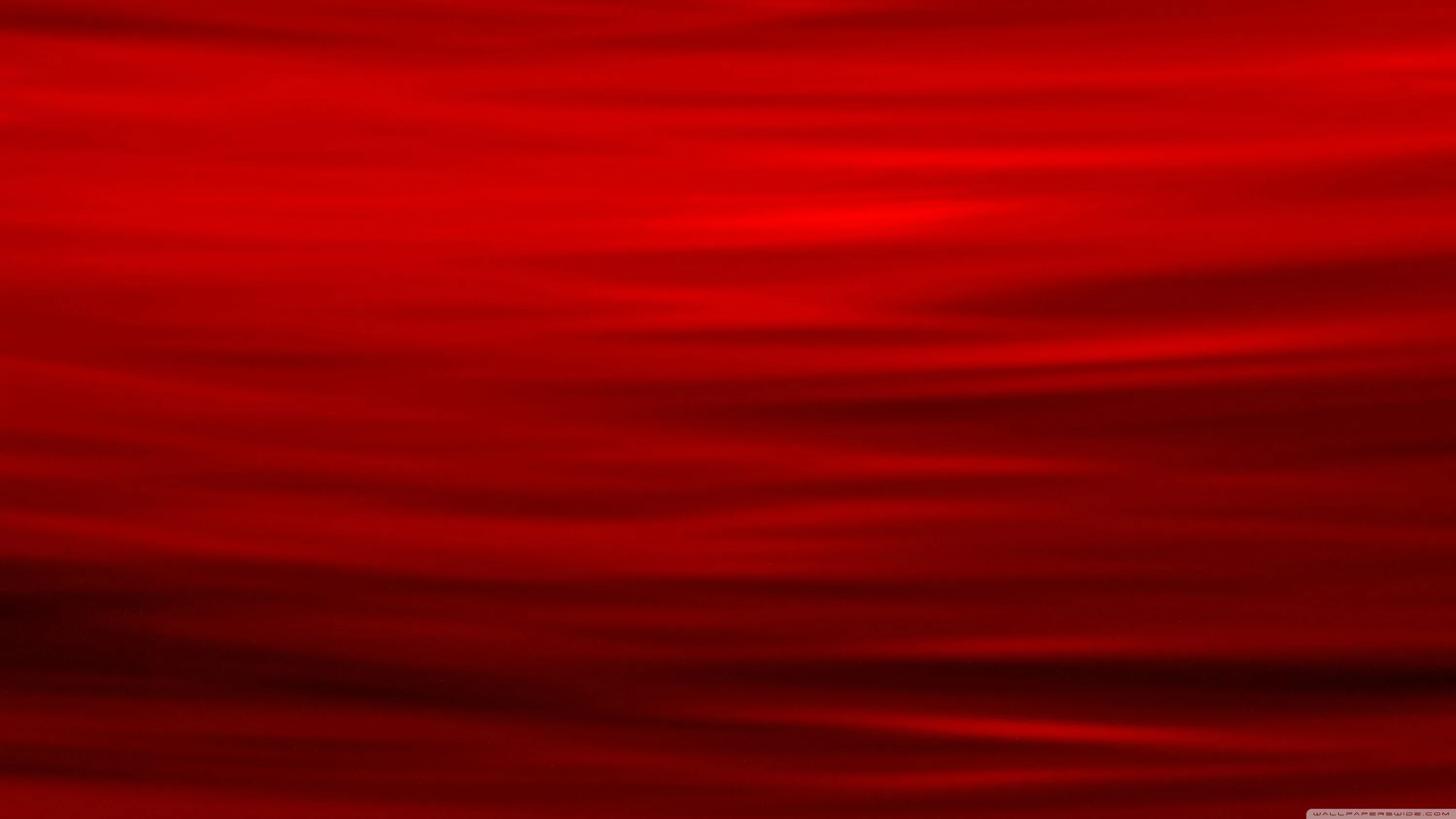 Horizontal bands of red blur into one another across the frame, deepening to near black along a single dark line low in the picture.