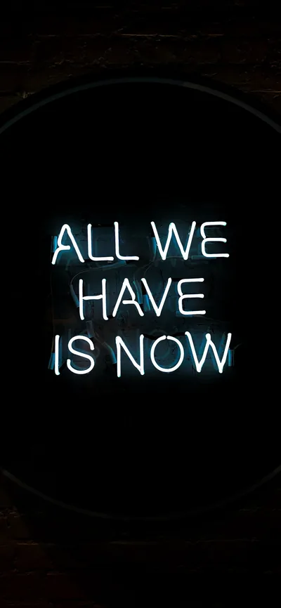 Pale blue neon letters spell out the phrase inside a dark circular frame, the wall around it barely visible.