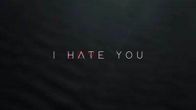 Thin spaced capitals read I hate you across a softly textured charcoal wall, only the middle word tinted red.