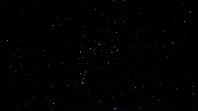 A clear night sky where the brighter stars group into a recognisable pattern near the centre, everything else falling away to black.