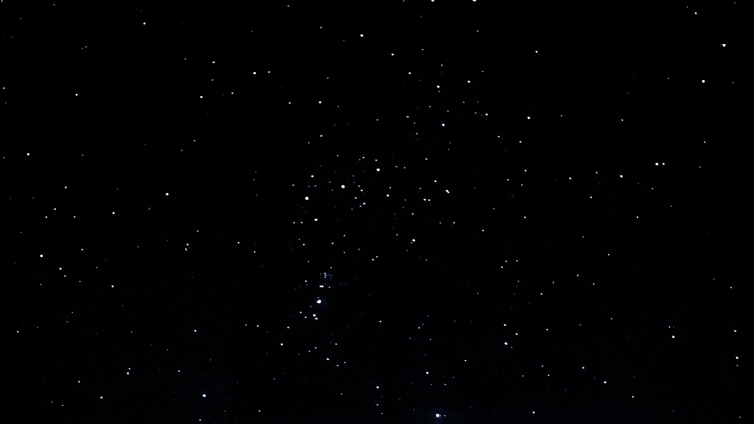 A clear night sky where the brighter stars group into a recognisable pattern near the centre, everything else falling away to black.