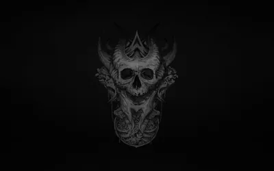 The same carved demon skull sits small at the centre of a wide, softly lit charcoal field, corners dropping to full black.