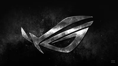 The ROG eye is carved in scratched silver over a rough dark wall, its highlights running along the upper edges of each stroke.