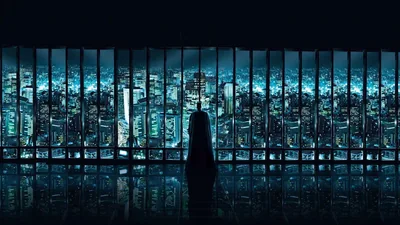 A lone figure stands in silhouette before a wall of tall windows, a blue-lit skyline spread out beyond the glass.