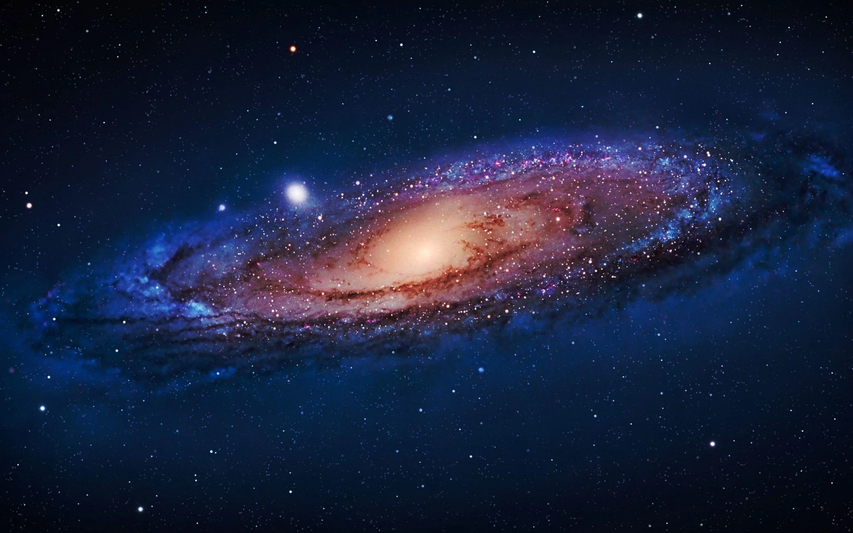 The Andromeda galaxy leans across the frame with a warm orange core, two small companion galaxies glowing nearby against the blue-black sky.