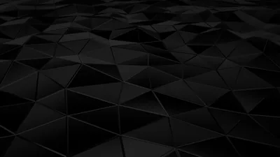 Faceted triangles tilt across a dark plane, each face catching a slightly different grey as the surface runs back into black.