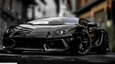 Low front-quarter shot with the buildings thrown out of focus behind, sunlight picking out the sharp creases along the bonnet and front splitter.