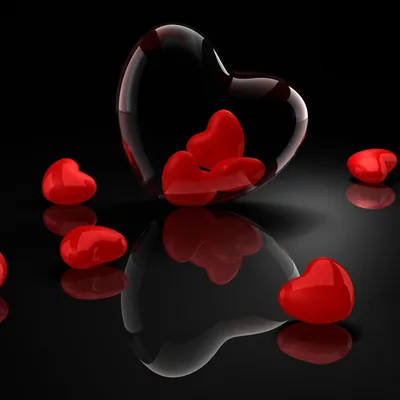 A hollow heart outline stands over glossy red hearts scattered on a mirrored black surface, each one doubled by its reflection.