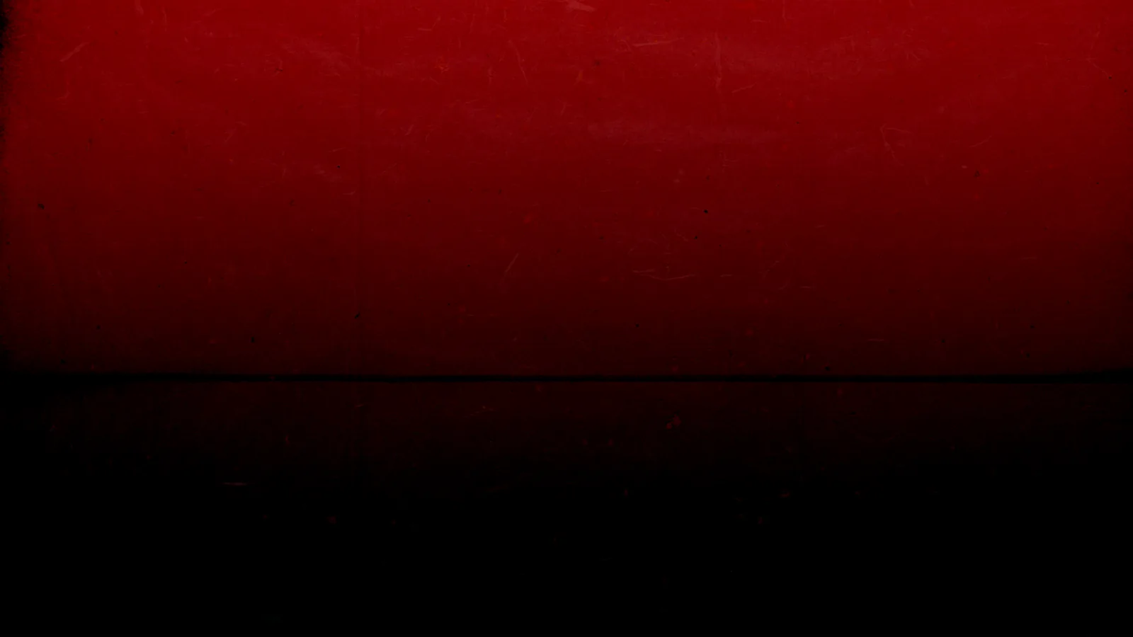 A wash of red covers the upper half and blurs into solid black below, faint scratches showing where the light catches the surface.