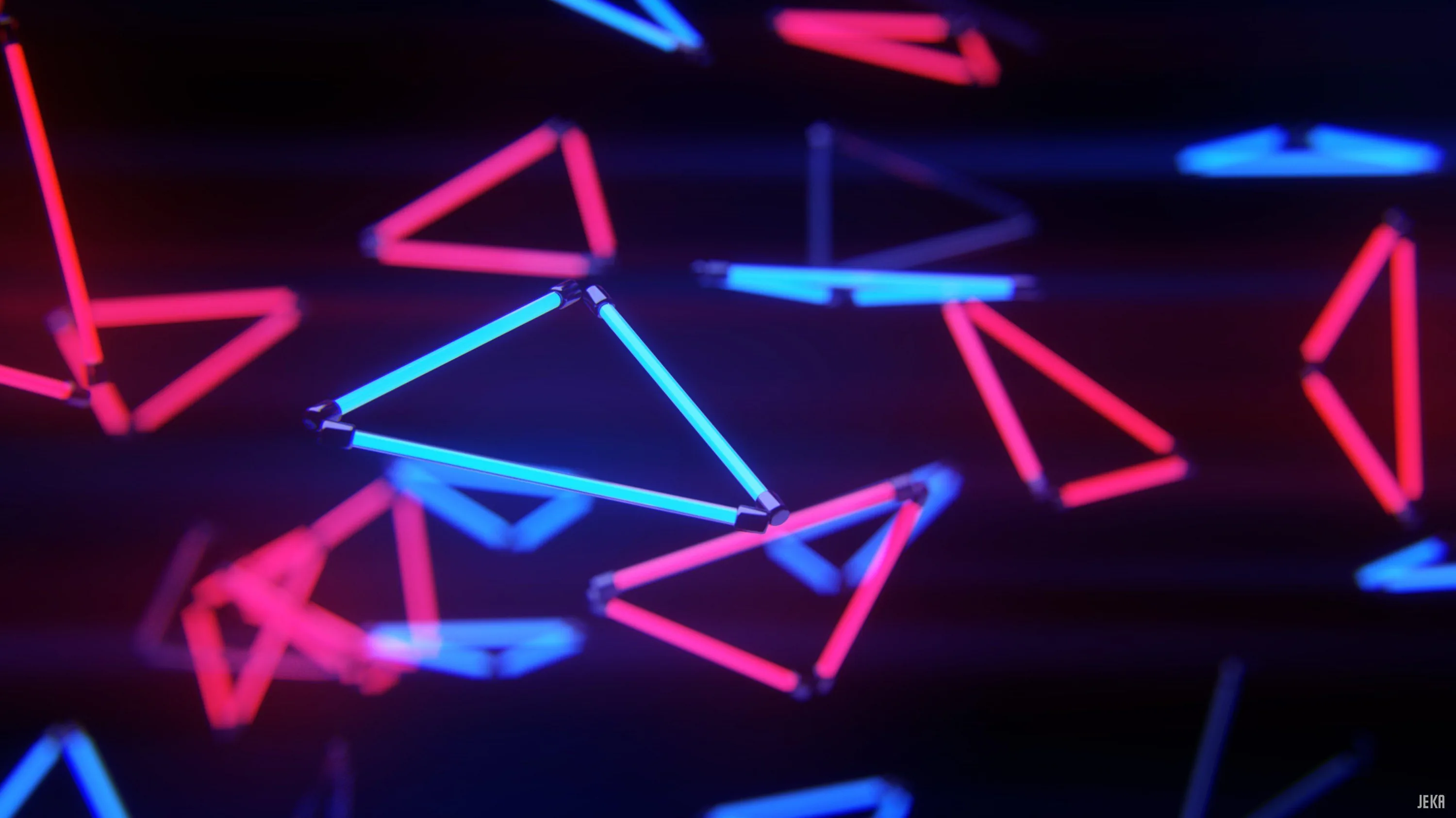 Red and blue outlined triangles drift at different depths through dark space, the nearer ones blurred into soft bokeh.