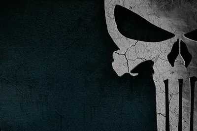 A wide skull emblem with long teeth is stencilled on rough dark blue concrete, chipped and flaking, with the left side clear for icons.