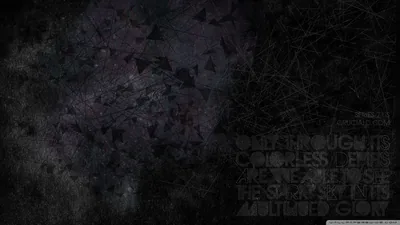 A scratched dark wall carries lines of barely readable type down the right side, the left left plain.