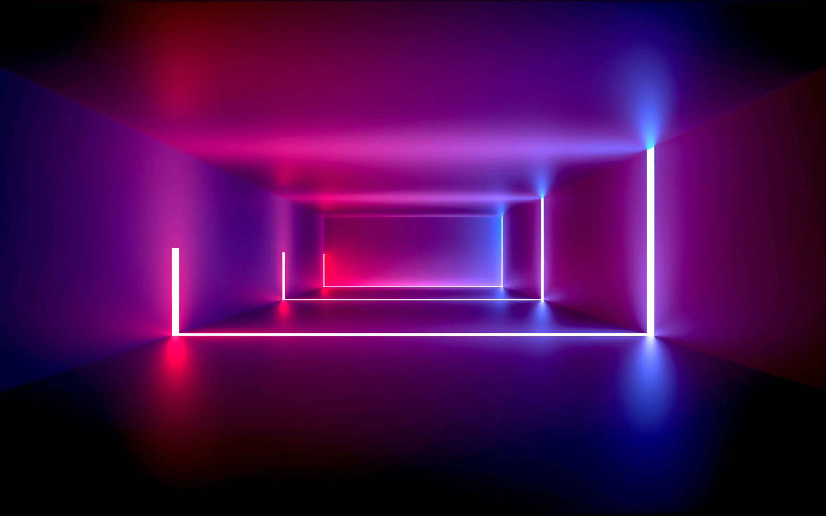A bare room with a reflective floor, lit only by pink and blue tube lights standing at the corners and running along the far wall.