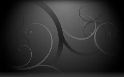 Large grey spirals curl across a dark grey field, the lines thinning as they wind toward their centres.