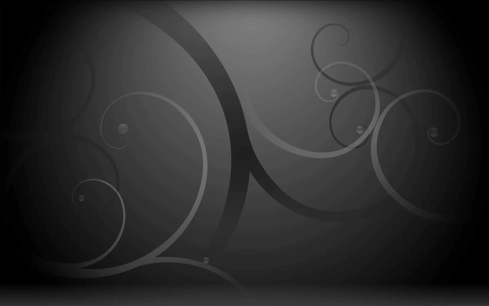 Large grey spirals curl across a dark grey field, the lines thinning as they wind toward their centres.