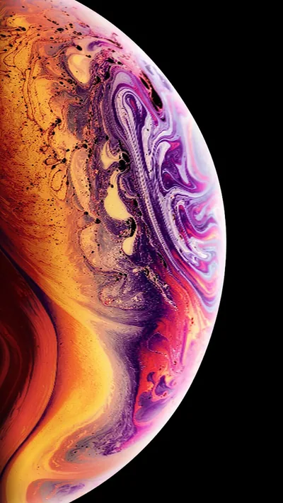 Swirls of gold, purple and cream curl across a planet that fills most of the frame, only a slim wedge of black surviving along the upper left.