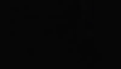 Almost the entire frame reads as pure black, with a few blocky forms barely lifting out of the dark toward the upper right.