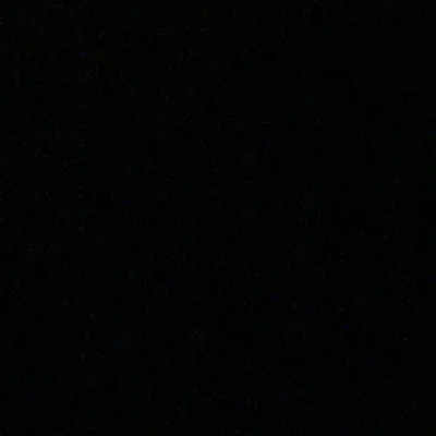 A flat true black square broken only by a scatter of faint grey specks — nothing to light up on an AMOLED display.