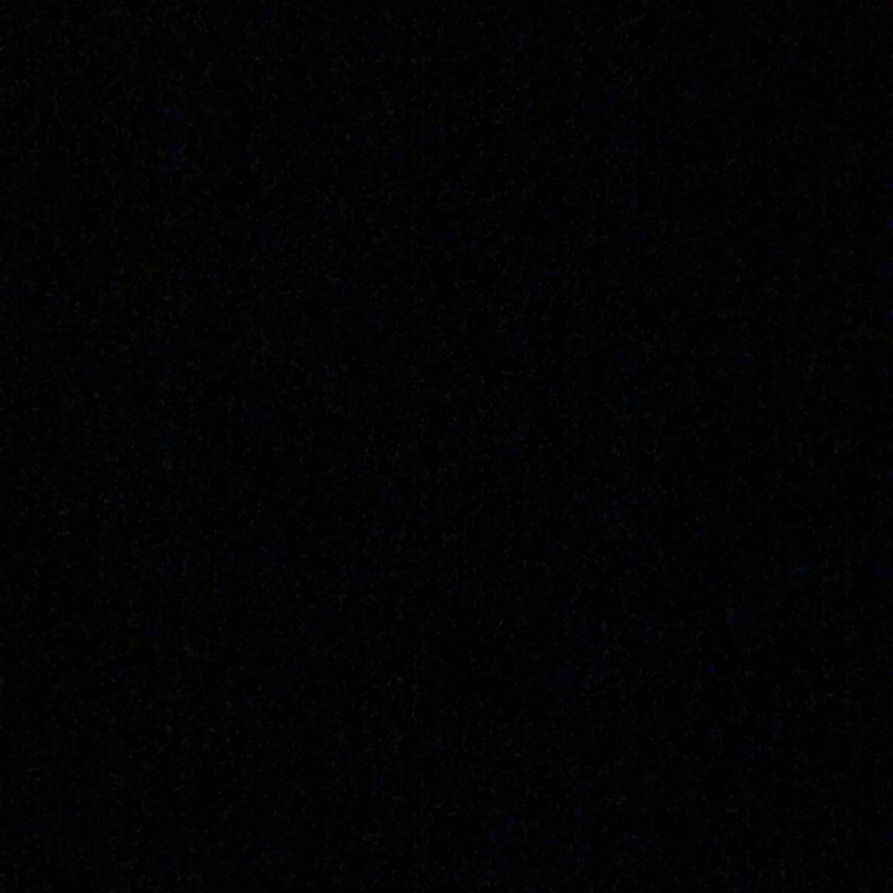A flat true black square broken only by a scatter of faint grey specks — nothing to light up on an AMOLED display.