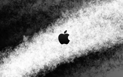The Apple logo sits in the middle of a rough white streak cutting diagonally across a dark grainy field, edges breaking up into speckles.