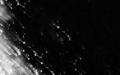 A diagonal burst of white specks and streaks sprays in from the lower left corner, thinning out into grain before it reaches the right side.