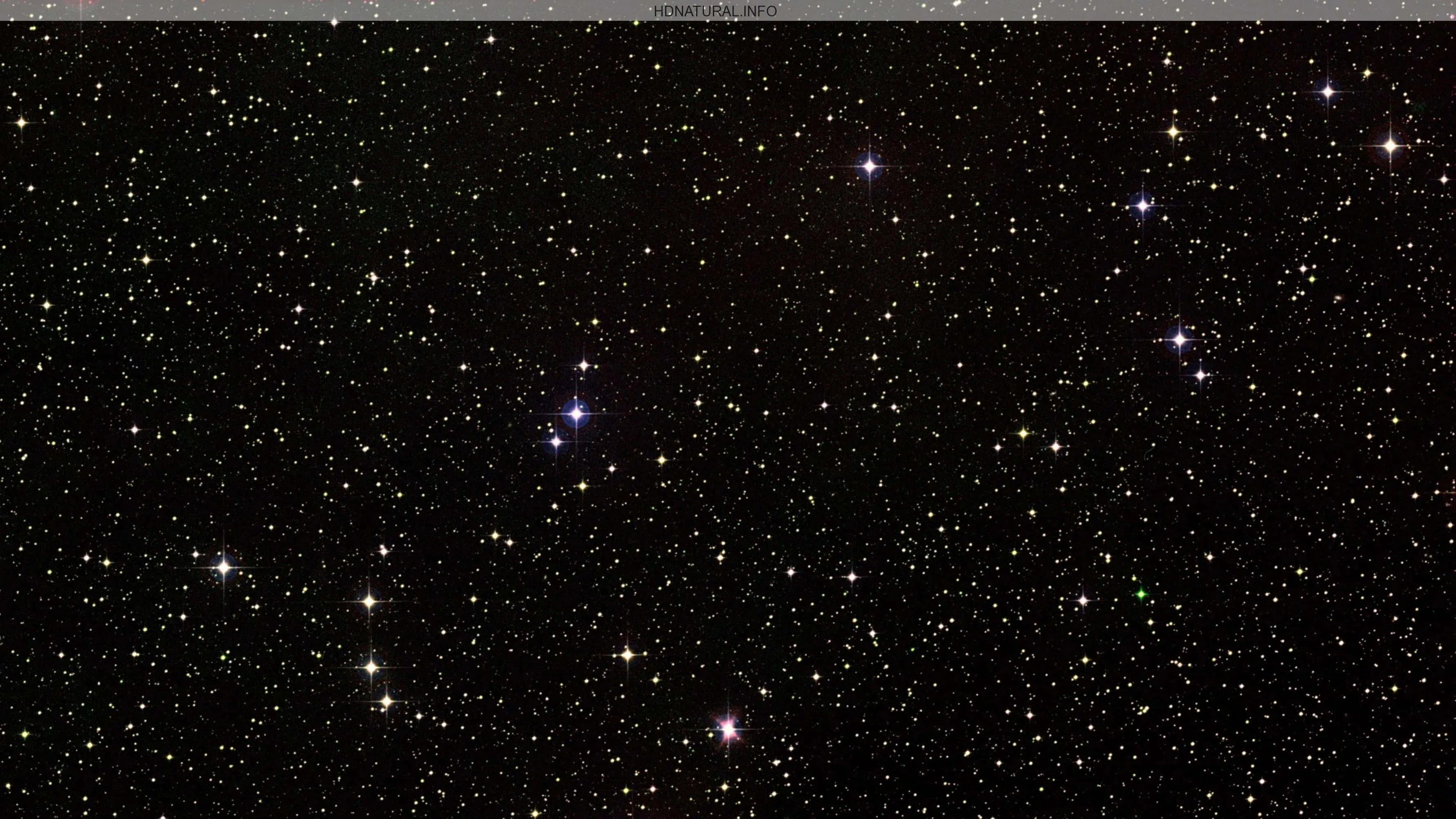 Telescope-style view of white and red pinpoint stars on black, cross spikes on the brightest few; the flat black suits battery-saving screens.