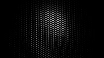 A hexagonal mesh runs across a dark panel, bright through the middle and falling into a heavy vignette at the corners.