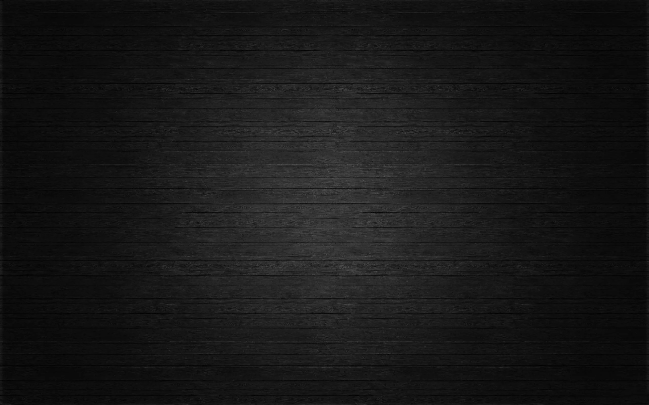 A quiet charcoal surface with fine horizontal grain and a soft vignette — made to sit behind icons without competing.