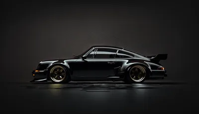 A slammed 930 with riveted arches and a whale tail stands in profile on a dark studio floor, gold wheels catching the one soft light source.