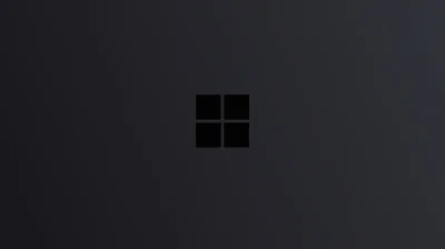 The four-pane Windows mark sits centred in near-black, a faint grey gradient sweeping in from the upper left to lift it off the background.
