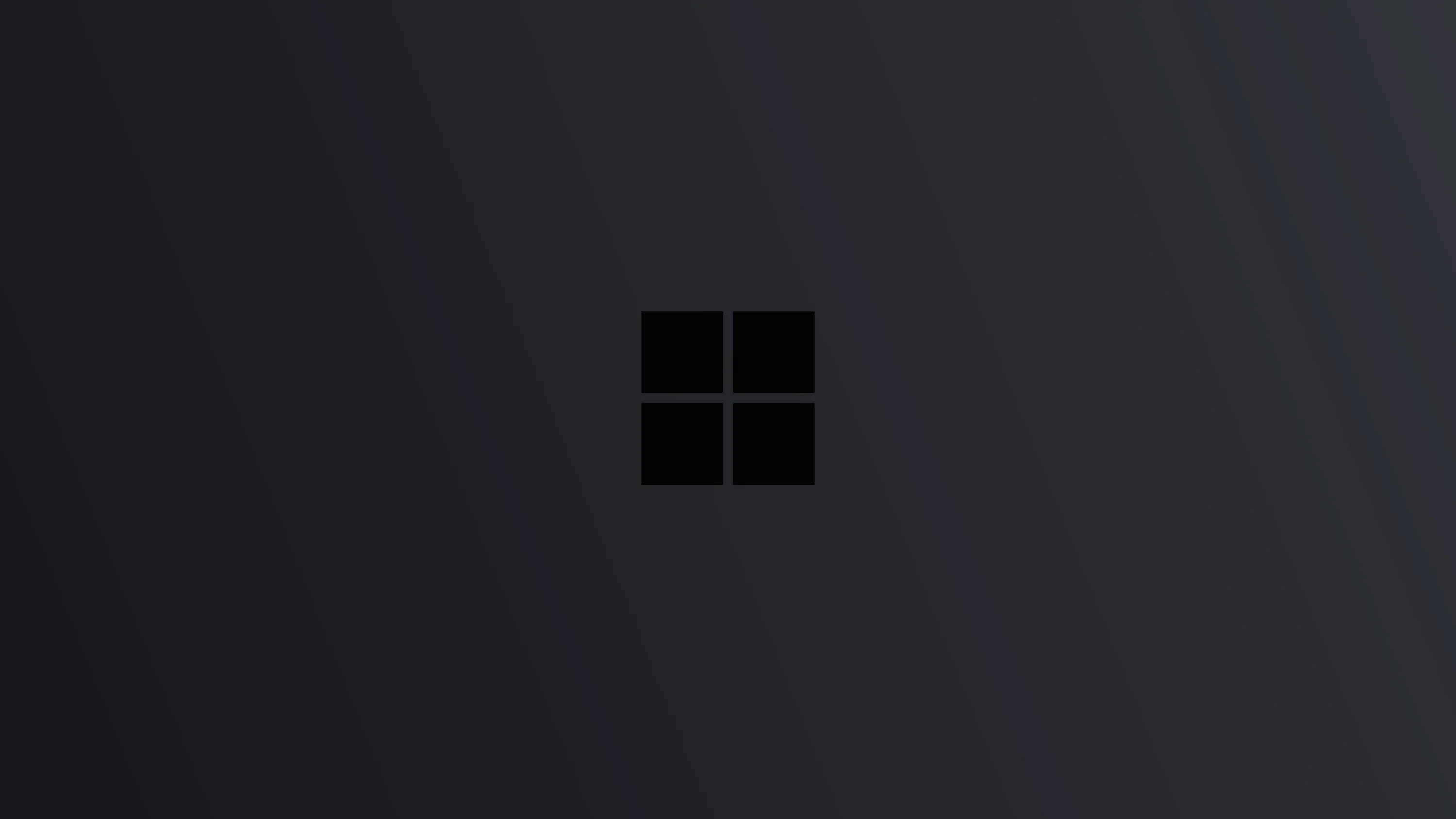 The four-pane Windows mark sits centred in near-black, a faint grey gradient sweeping in from the upper left to lift it off the background.
