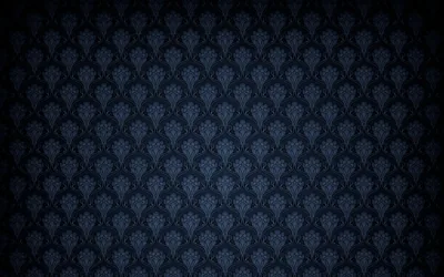 A subtle damask motif in charcoal navy, lit brightest through the middle and shaded down hard into all four corners.