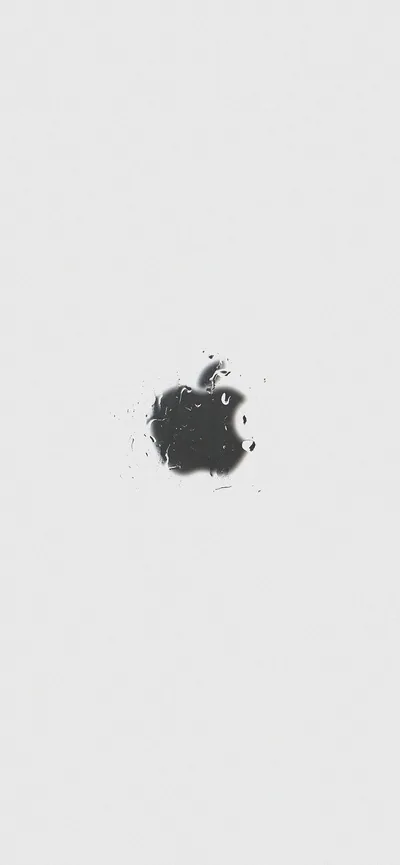 A black Apple mark in rough splatter texture sits just left of centre on a pale grey field, every other part of the frame empty.