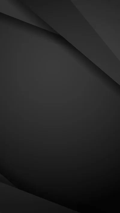 Two faint creases run down from the top corners across a smooth charcoal surface that darkens toward the bottom.