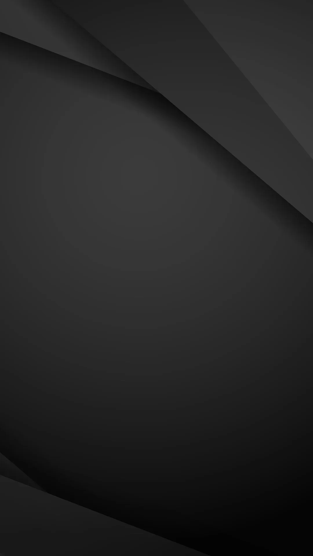 Two faint creases run down from the top corners across a smooth charcoal surface that darkens toward the bottom.