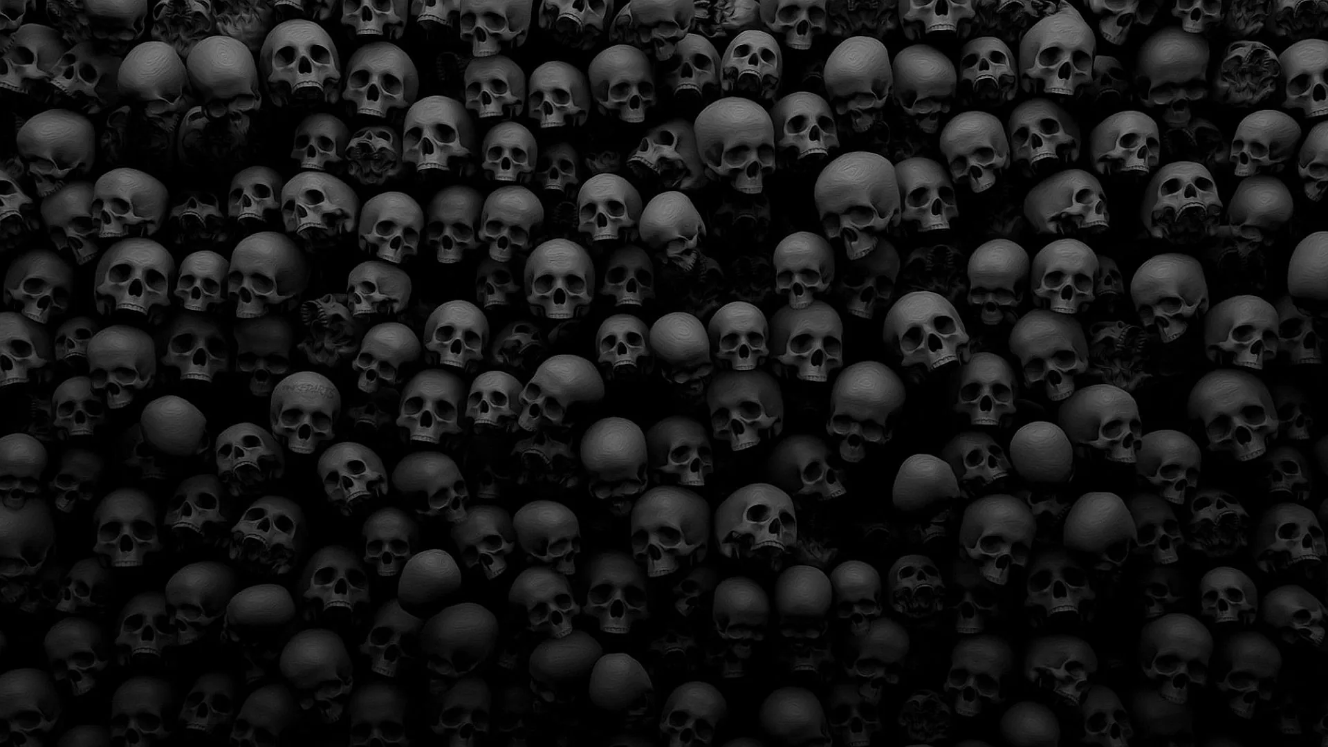 Row after row of skulls fill the entire frame in dim grey, the light falling off toward the corners so the edges go almost black.
