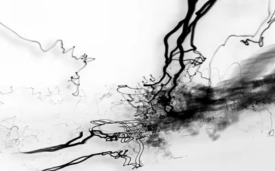 Wet black ink runs and spatters across white, dense on the right and thinning into stray hairline threads on the left.