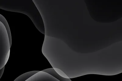 Smooth grey curves fold over each other in the upper right of a wide black frame, the left side left almost entirely empty.