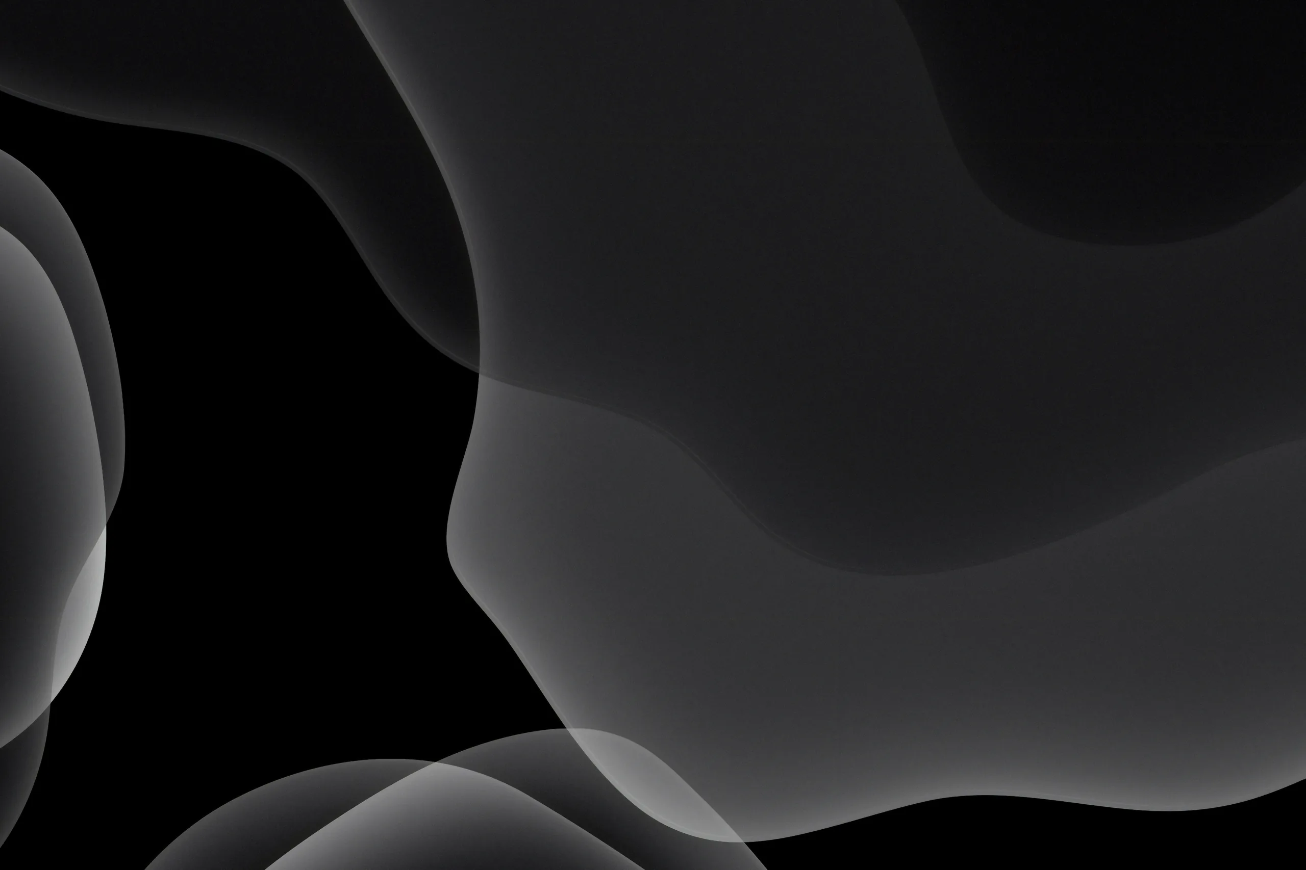Smooth grey curves fold over each other in the upper right of a wide black frame, the left side left almost entirely empty.