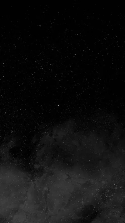 Scattered stars fill the upper half of a tall black sky while pale cloud banks roll in across the bottom third in grey monochrome.