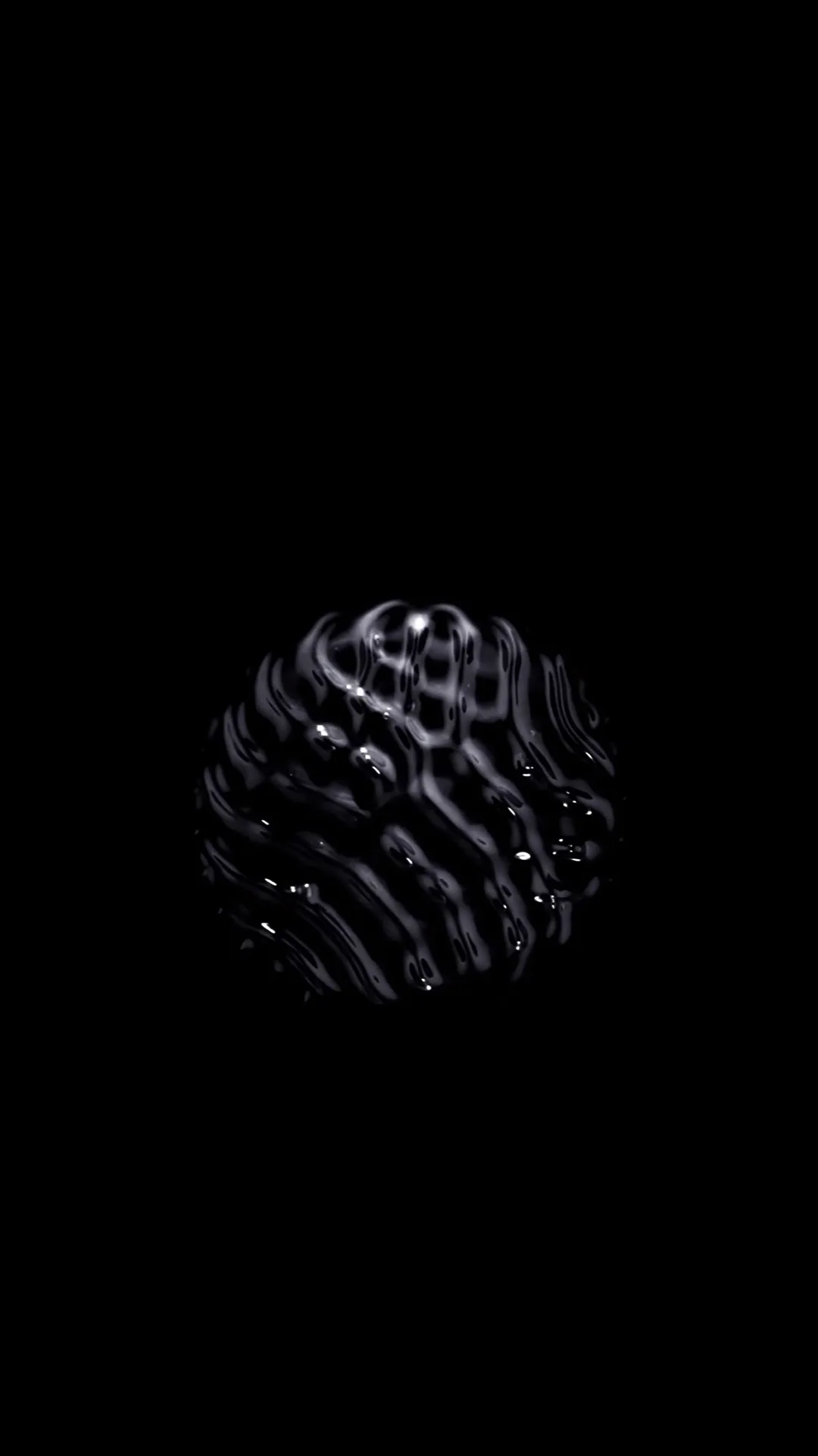 A small sphere covered in coiled ridges floats dead centre on pure black, lit from the upper left so the grooves throw their own shadows.