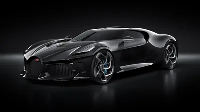 The one-off Bugatti stands three-quarter on in a pitch black room, a single soft light tracing the long spine down its roof and the six tail pipes at the back.